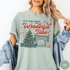 Comfort Colors tee in Bay featuring Christmas design with a decorated tree and a cozy fireplace scene
