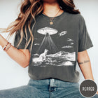 Comfort Colors tee in Pepper featuring retro graphic style cat and UFO abduction scene in white ink