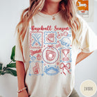 Comfort Colors tee in Ivory featuring baseball icons including bats, a glove, stadium, and trophy graphic design