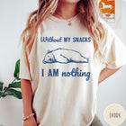 Comfort Colors tee in Ivory featuring illustrated bear graphic with text Without My Snacks I Am Nothing