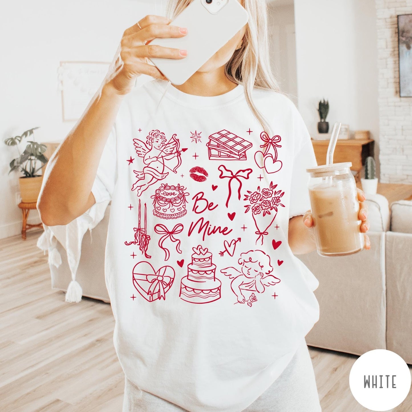Comfort Colors tee in White featuring Valentine's Day collage graphic with cupid, cakes, and romantic symbols.