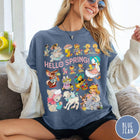 Comfort Colors tee in Blue Jean featuring vintage style graphic with spring animals and children illustrations