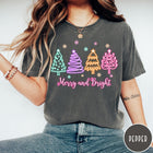 Comfort Colors tee in Pepper featuring neon Christmas tree graphic with Merry and Bright text and snowflakes