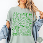 Comfort Colors tee in Bay featuring line art style St. Patrick's Day icons including shamrocks and leprechaun hat