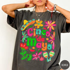Comfort Colors tee in Pepper featuring festive Cinco de Mayo graphic with sombrero, maracas, and colorful flowers
