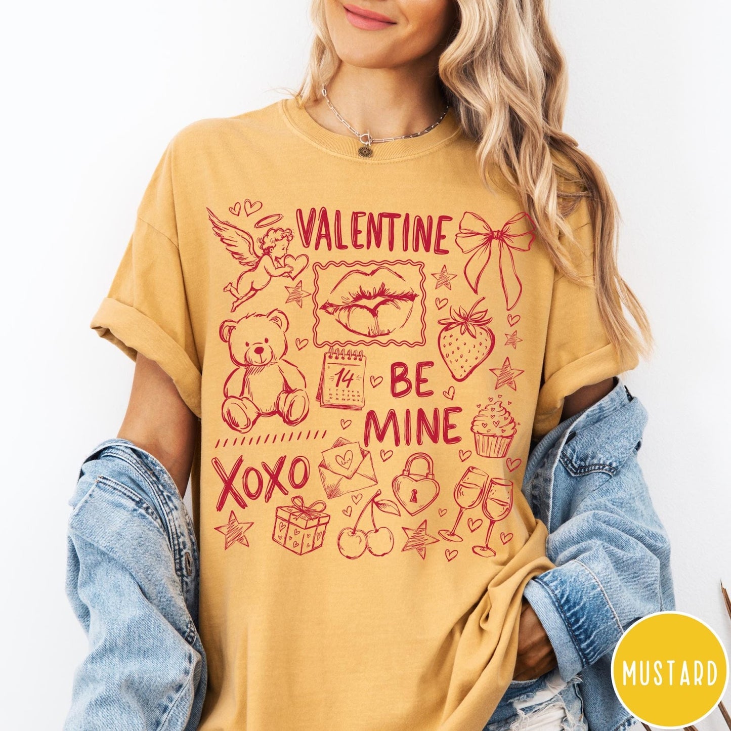 Comfort Colors tee in Mustard featuring Valentine's Day collage graphic with cupid, teddy bear, and romantic symbols