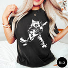 Comfort Colors tee in Black featuring rock music style graphic of a cat playing an electric guitar