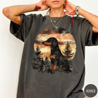 Comfort Colors tee in Pepper featuring vintage style dachshund dog graphic with forest and sunset background