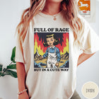 Comfort Colors tee in Ivory featuring cartoon style graphic of a girl holding a knife in flames