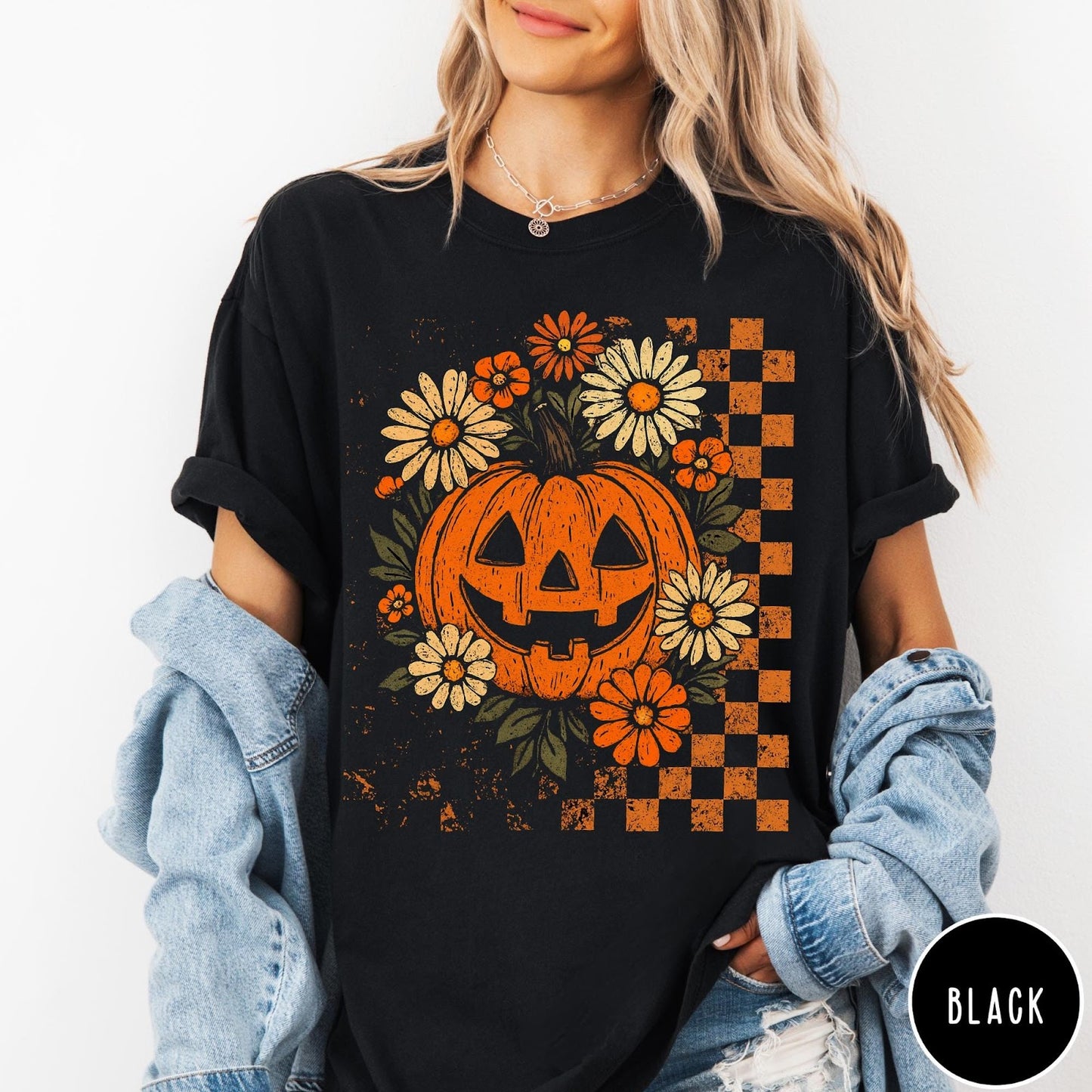 Comfort Colors tee in Black featuring retro floral jack-o'-lantern graphic with a checkered pattern side design