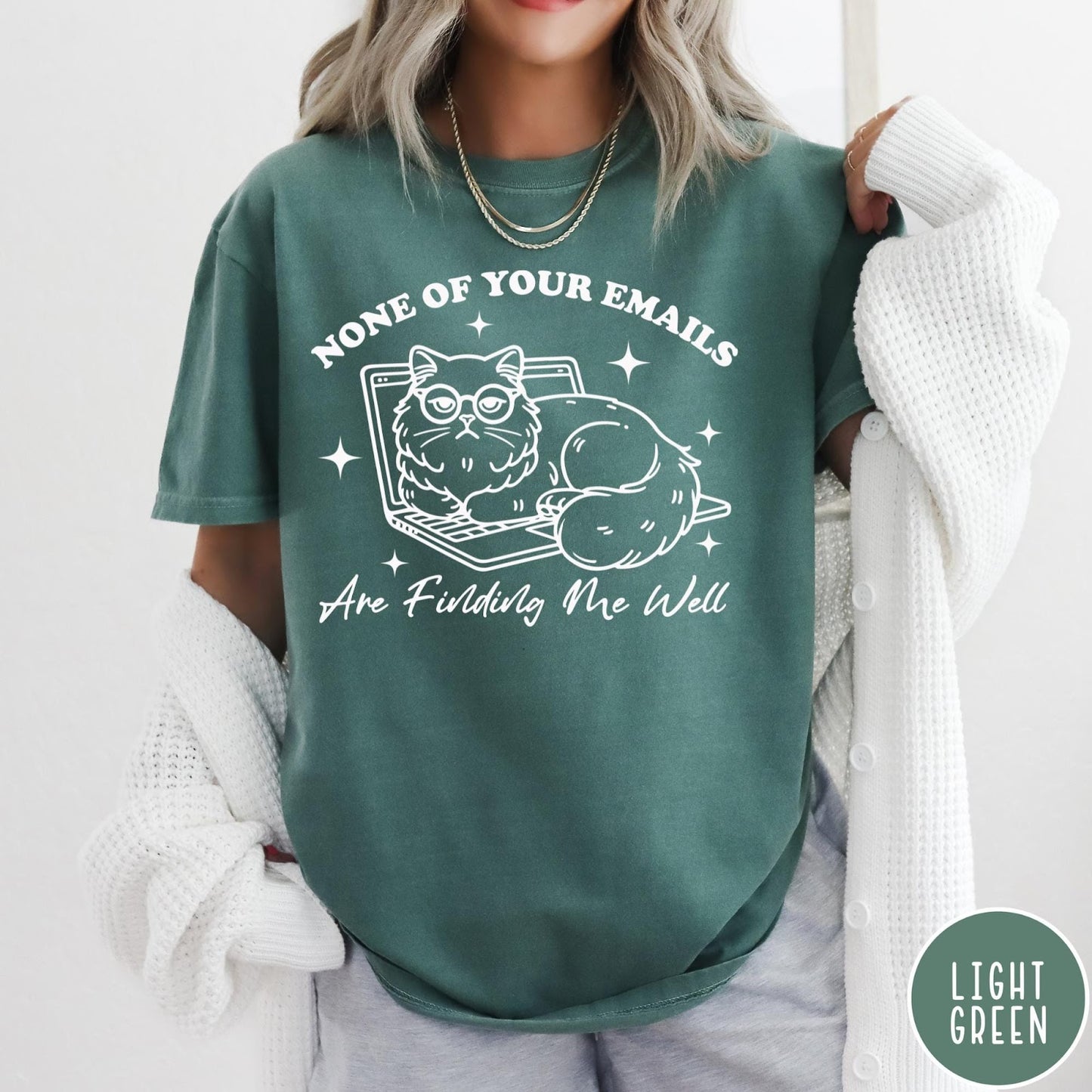 Comfort Colors tee in Light Green featuring white line art of a grumpy cat wearing glasses on a laptop