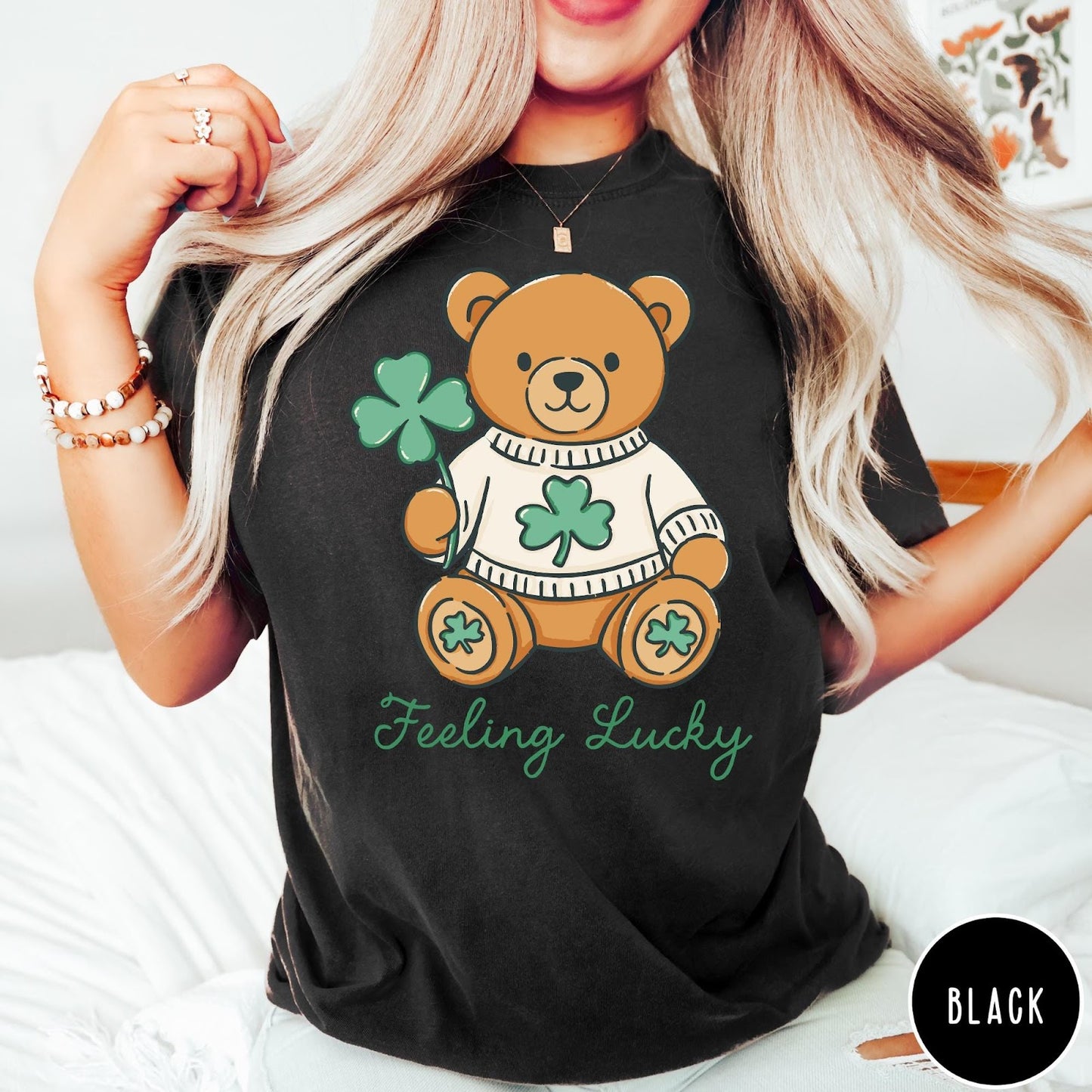 Comfort Colors tee in Black featuring illustrated teddy bear wearing a sweater and holding a four-leaf clover