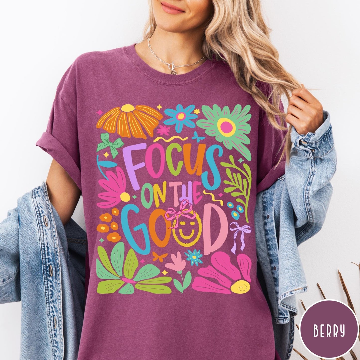 Comfort Colors tee in Berry featuring colorful typography and floral collage with a smiley face graphic design
