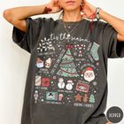 Comfort Colors tee in Pepper featuring festive holiday graphic with Christmas icons like a tree and cocoa