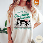 Comfort Colors tee in Ivory featuring vintage style graphic of a tuxedo cat in grass with text