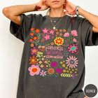 Comfort Colors tee in Pepper featuring floral wildflowers design with Happiness Blooms Within text graphic description