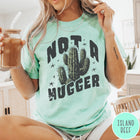 Comfort Colors tee in Island Reef featuring cactus graphic and Not a Hugger text with small stars