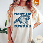 Comfort Colors tee in Ivory featuring screen printed raccoon graphic with Fight Me Coward text design