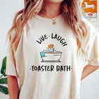 Comfort Colors tee in Ivory featuring cute graphic style of a smiling toaster sitting in a bathtub