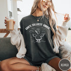 Comfort Colors tee in Pepper featuring line art graphic of a goose with a halo and wings