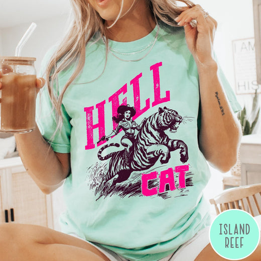 Comfort Colors tee in Island Reef featuring retro design of a cowgirl riding a tiger with pink text