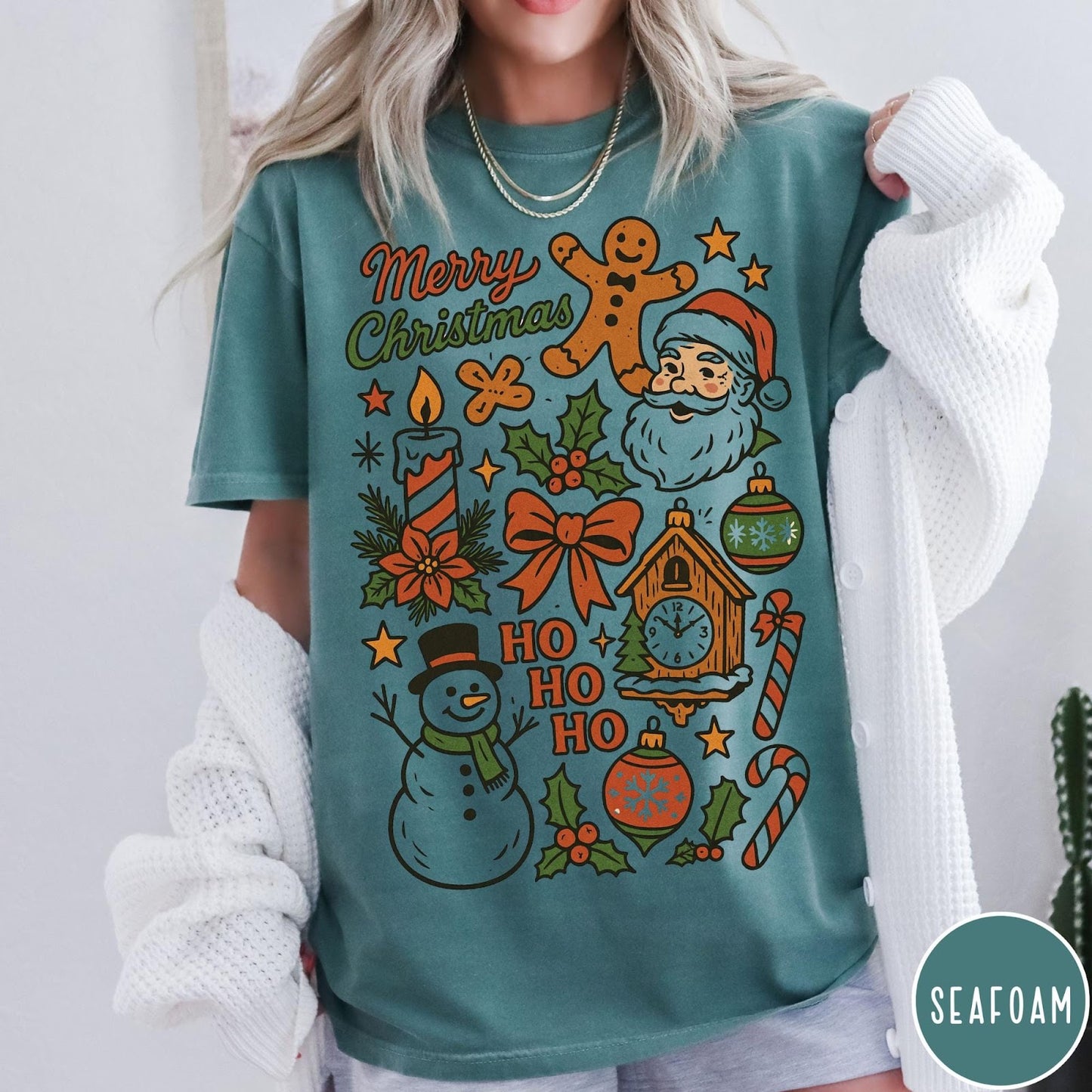 Comfort Colors tee in Seafoam featuring retro holiday design with Christmas icons like Santa and a snowman