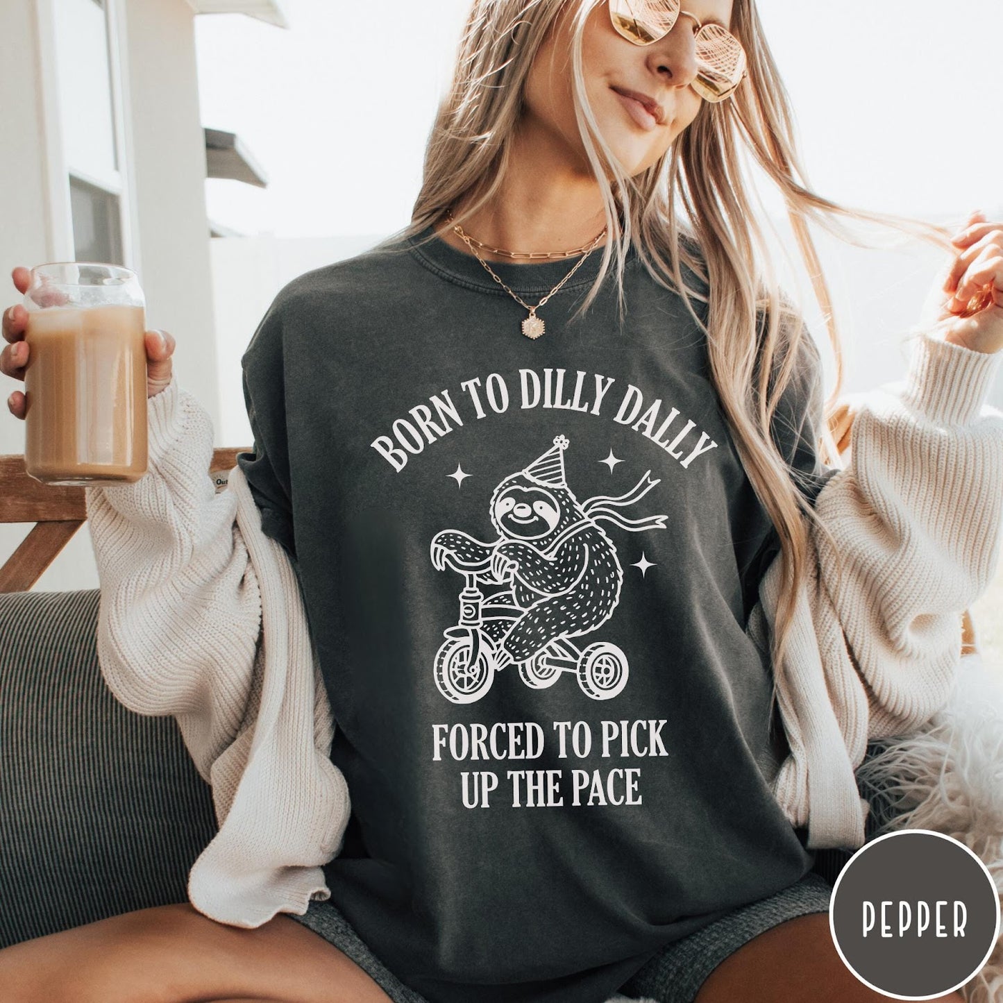 Comfort Colors tee in Pepper featuring cute sloth on a tricycle graphic with Born to Dilly Dally text