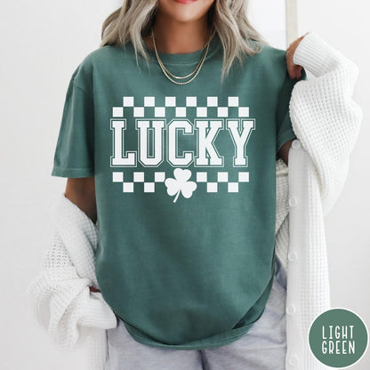 Comfort Colors tee in Light Green featuring checkerboard design with Lucky text and a shamrock graphic