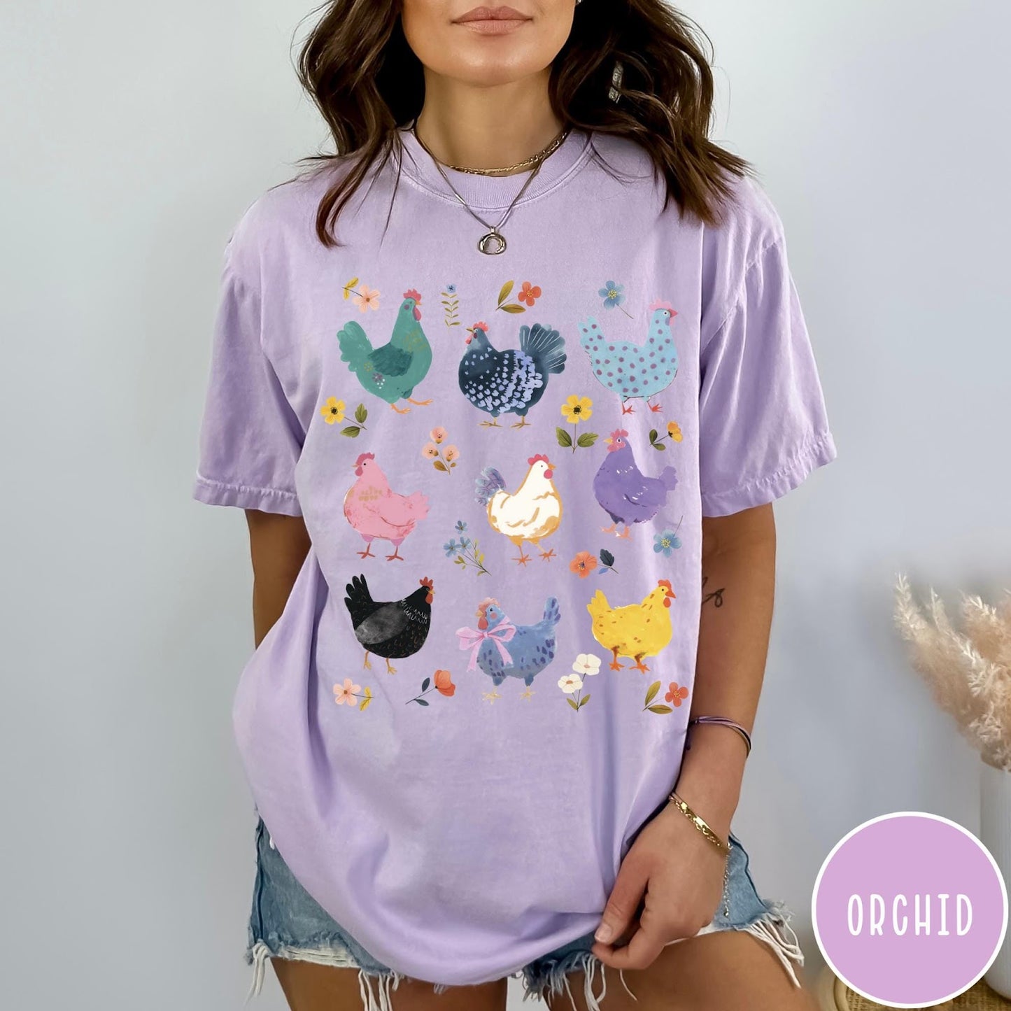 Comfort Colors tee in Orchid featuring vintage style graphic with various colorful chickens and small floral accents