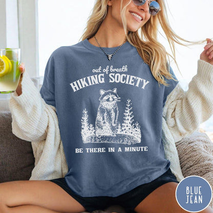 Comfort Colors tee in Blue Jean featuring outdoor style graphic of a raccoon standing in the forest