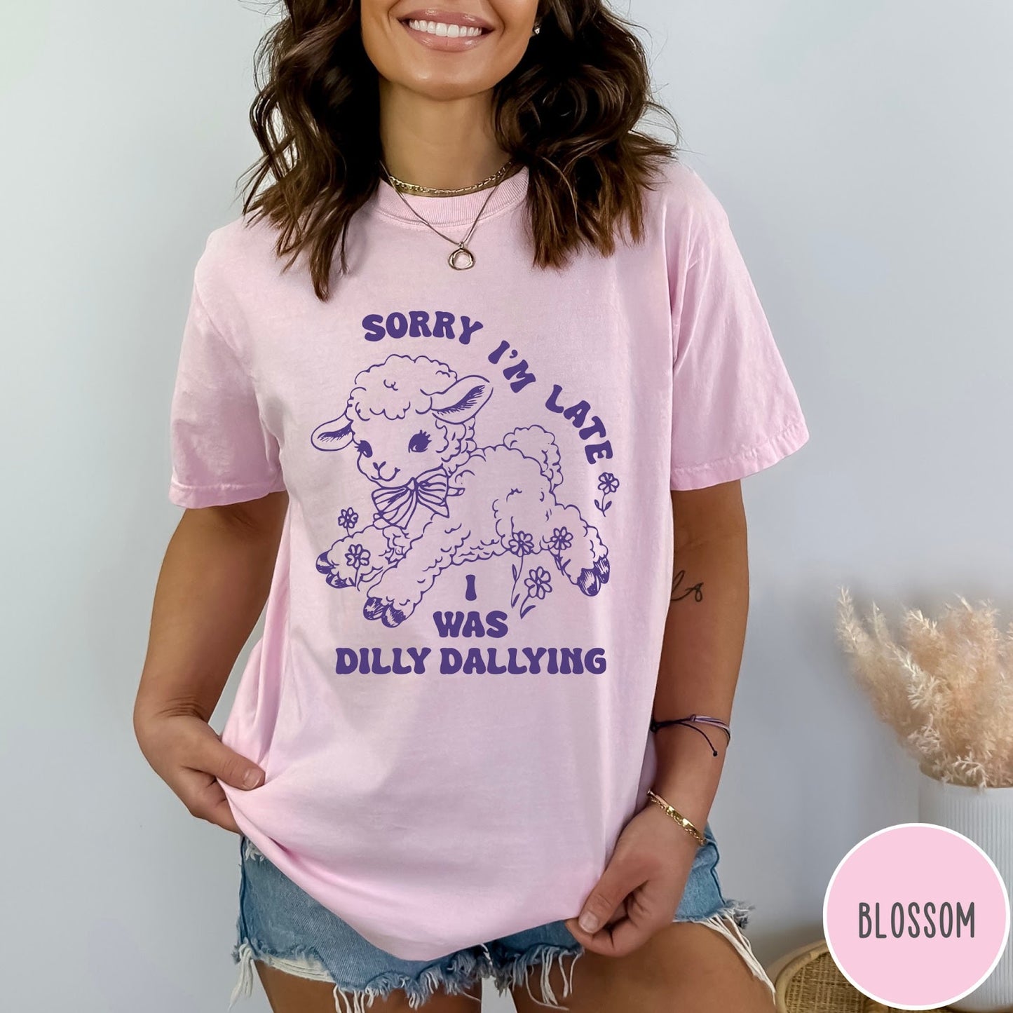 Comfort Colors tee in Blossom featuring line art graphic of a lamb with flowers and text