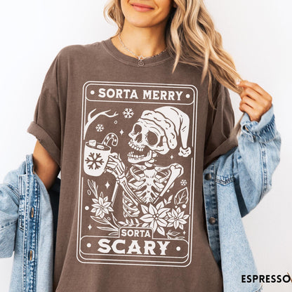 Comfort Colors tee in Espresso featuring graphic design of a skeleton in a Santa hat holding cocoa