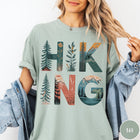 Comfort Colors tee in Bay featuring nature graphic with trees and mountains inside the word Hiking