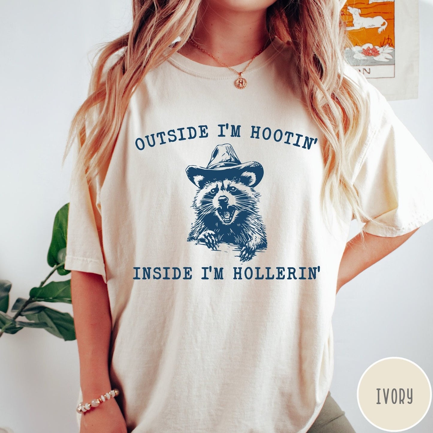 Comfort Colors tee in Ivory featuring western style graphic of a raccoon wearing a cowboy hat