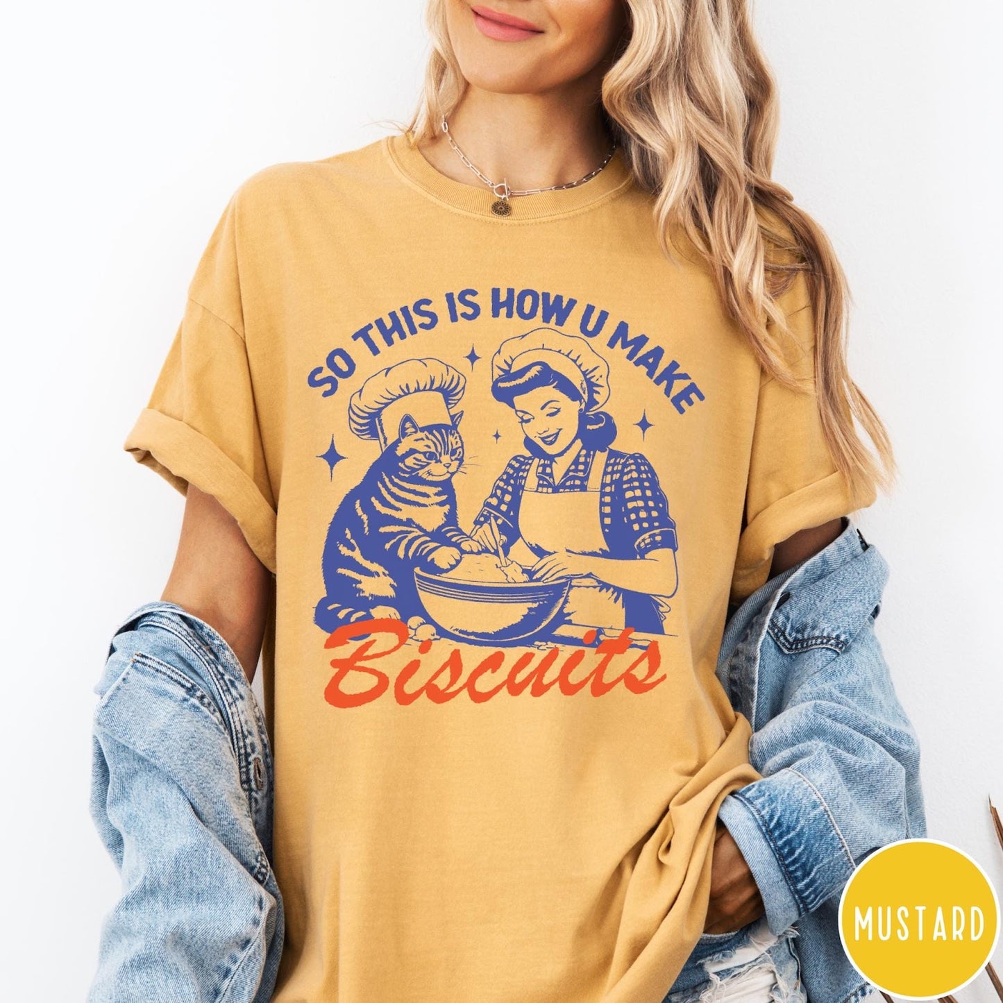 Comfort Colors tee in Mustard featuring vintage style graphic of a woman and cat baking biscuits together