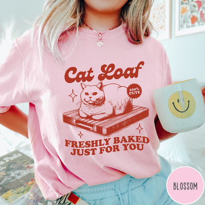 Comfort Colors tee in Blossom featuring graphic style cat loaf sitting on a wooden cutting board