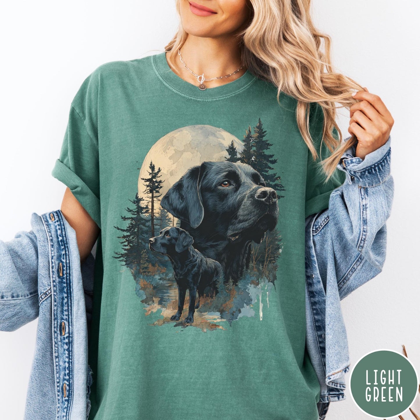 Comfort Colors tee in Light Green featuring nature style graphic of black Labrador dogs in a forest moon scene