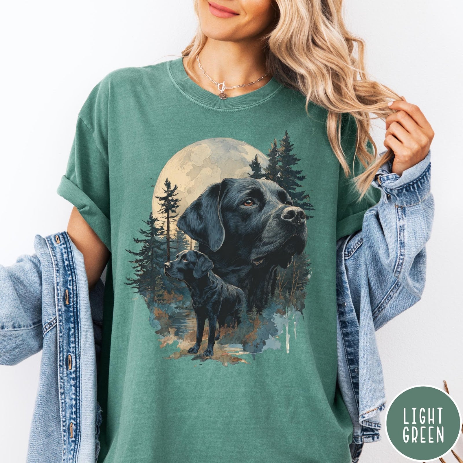 Comfort Colors tee in Light Green featuring nature style graphic of black Labrador dogs in a forest moon scene