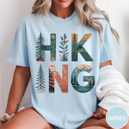 Comfort Colors tee in Chambray featuring nature graphic with trees and mountains inside the word Hiking