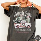 Comfort Colors tee in Pepper featuring vintage style Christmas tree farm truck graphic with snowy pine trees