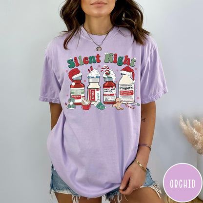 Comfort Colors tee in Orchid featuring holiday graphic with medical vials styled as festive holiday treats