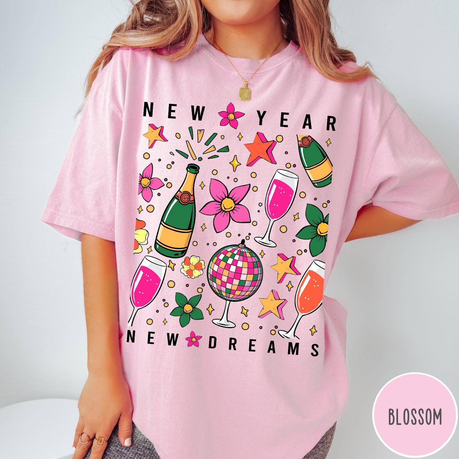 Comfort Colors tee in Blossom featuring New Year celebration graphic with champagne bottles, glasses, and disco ball