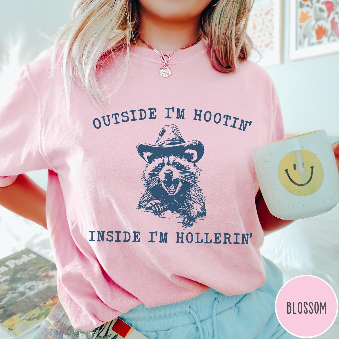 Comfort Colors tee in Blossom featuring western style graphic of a raccoon wearing a cowboy hat
