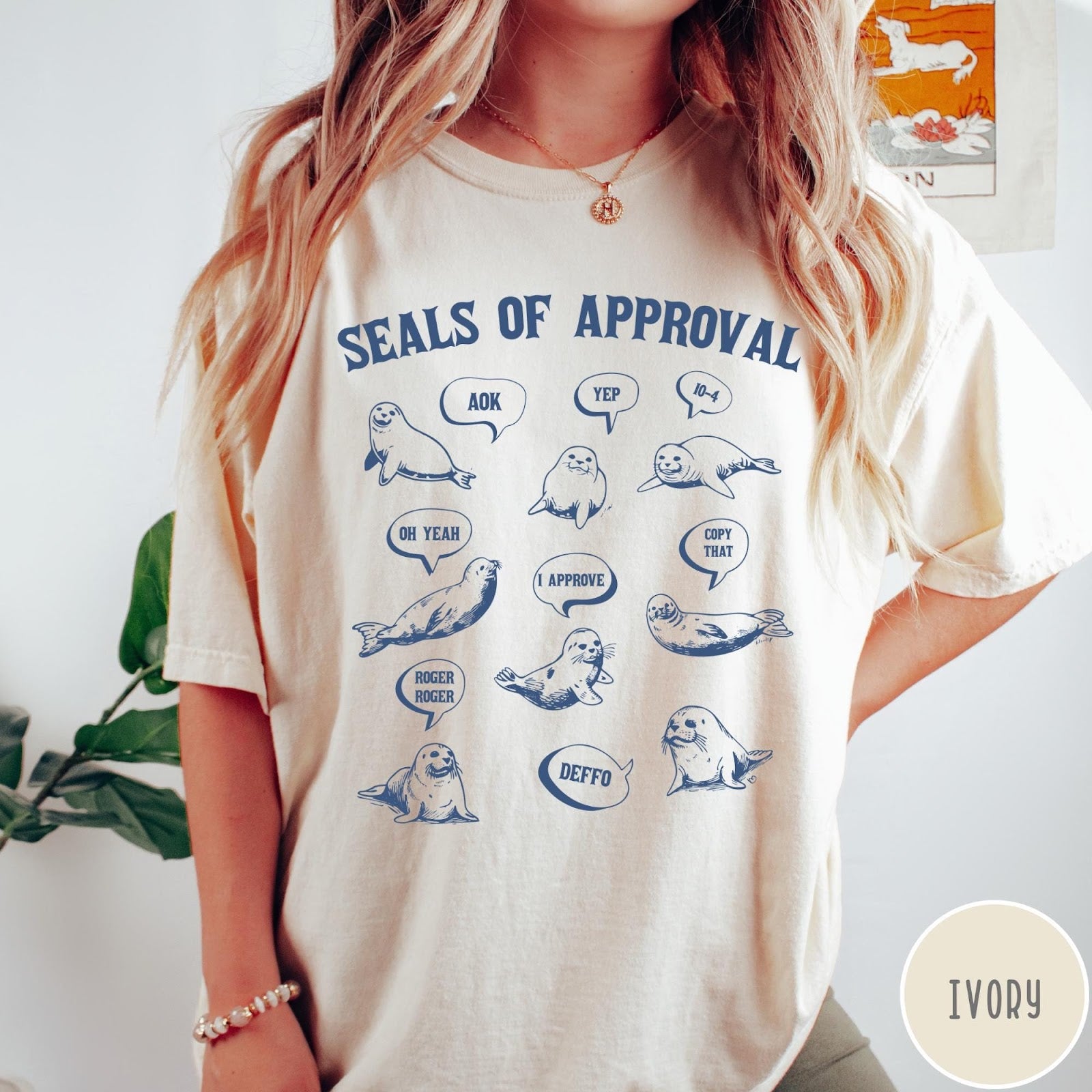 Comfort Colors tee in Ivory featuring illustrative style graphic with multiple seals and speech bubbles saying approval phrases