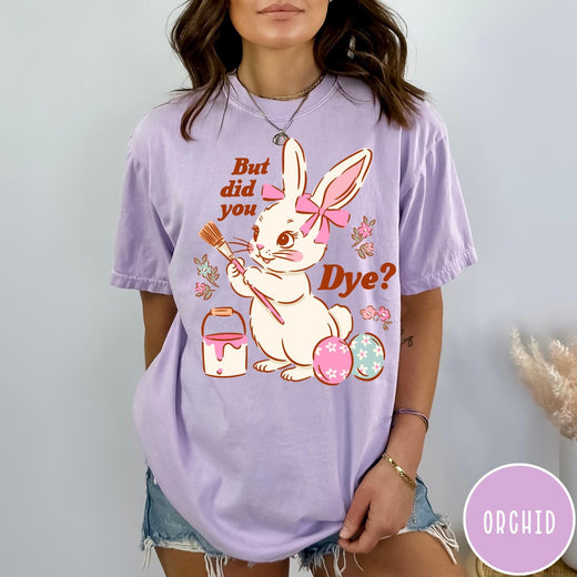 Comfort Colors tee in Orchid featuring cute Easter bunny graphic with paintbrush and painted Easter eggs.