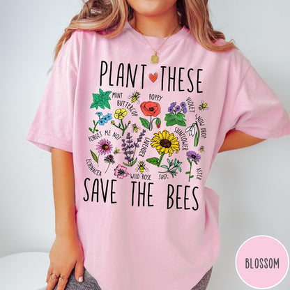 Comfort Colors tee in Blossom featuring botanical garden style graphic with various flowers and bees