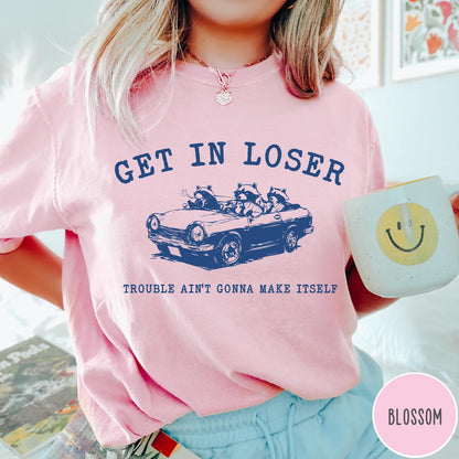 Comfort Colors tee in Blossom featuring vintage style graphic of three raccoons driving a convertible car
