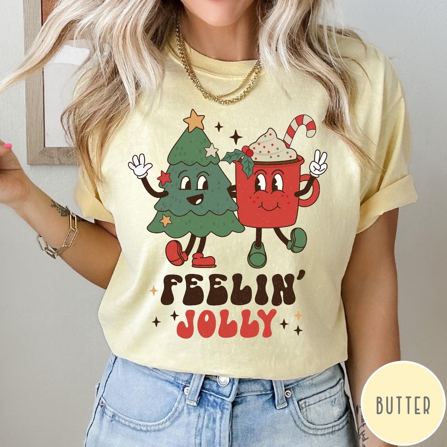 Comfort Colors tee in Butter featuring retro style graphic of a cartoon Christmas tree and cocoa mug