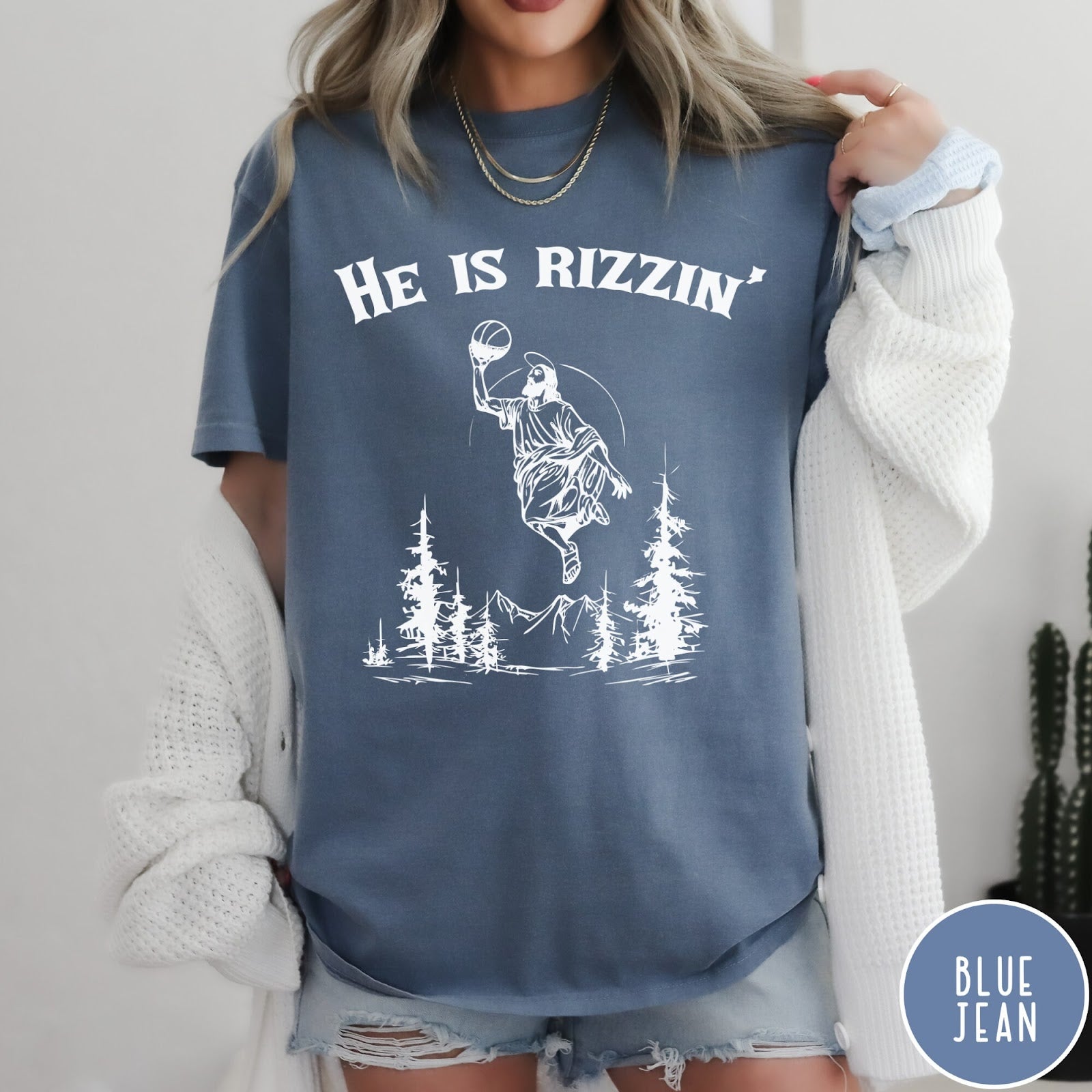 Comfort Colors tee in Blue Jean featuring graphic style Jesus playing basketball with mountains and pine trees illustration
