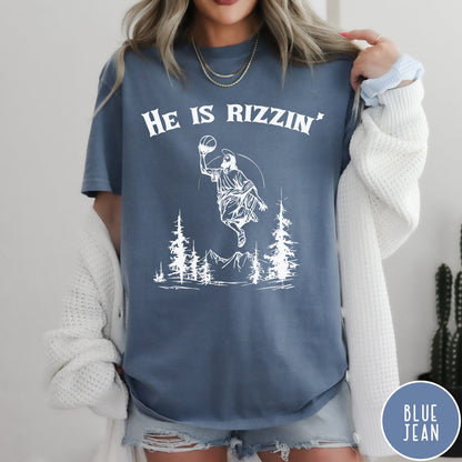 Comfort Colors tee in Blue Jean featuring graphic style Jesus playing basketball with mountains and pine trees illustration
